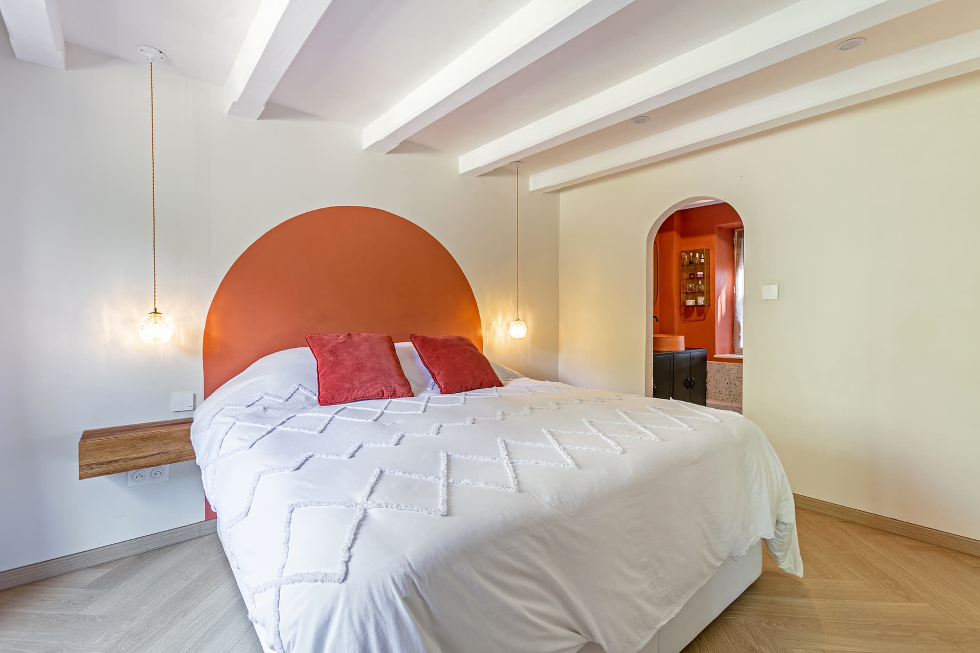 Double bed and arched doorway to the en-suite