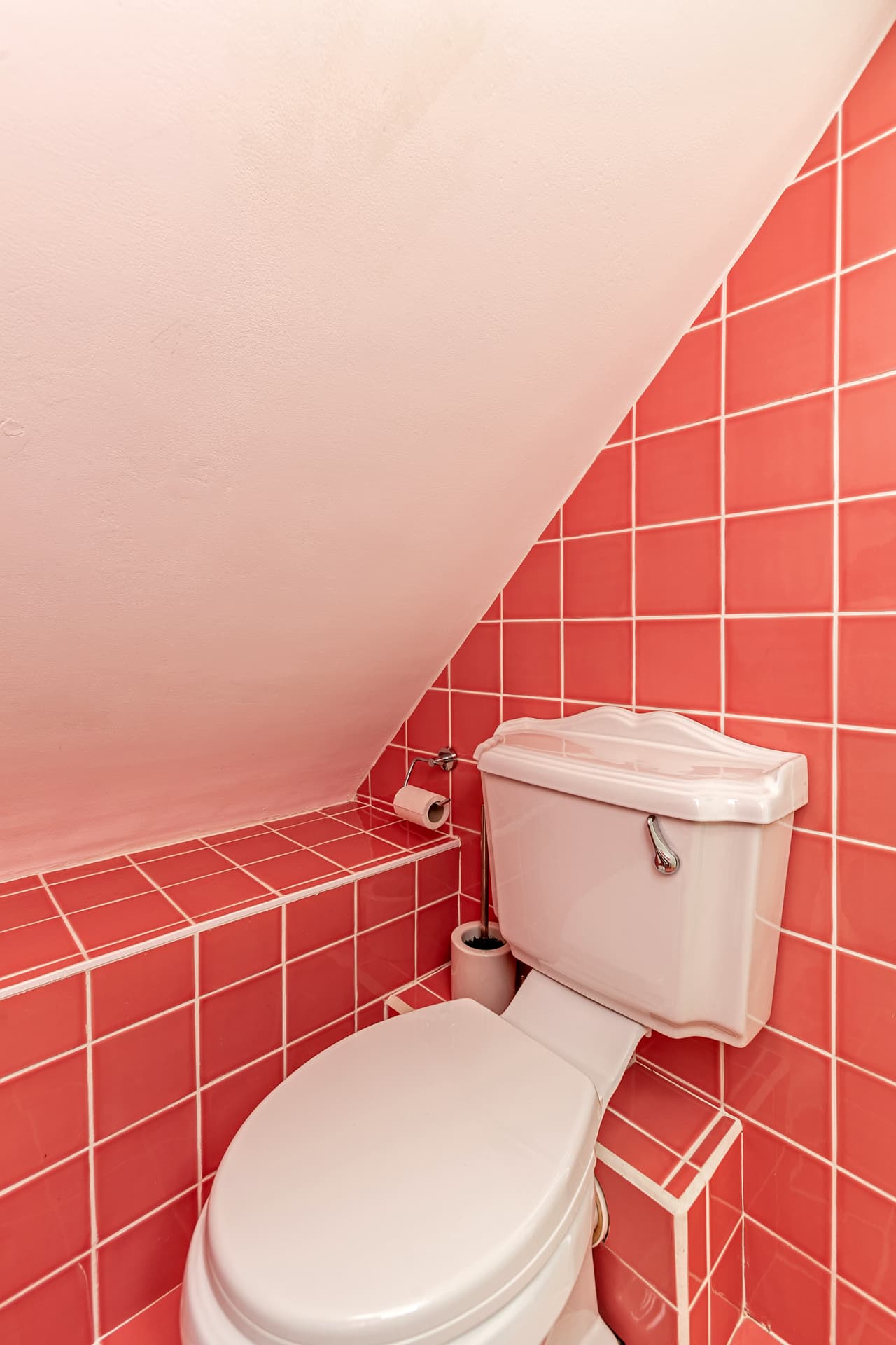 Pink-tiled bathroom detail under the eaves