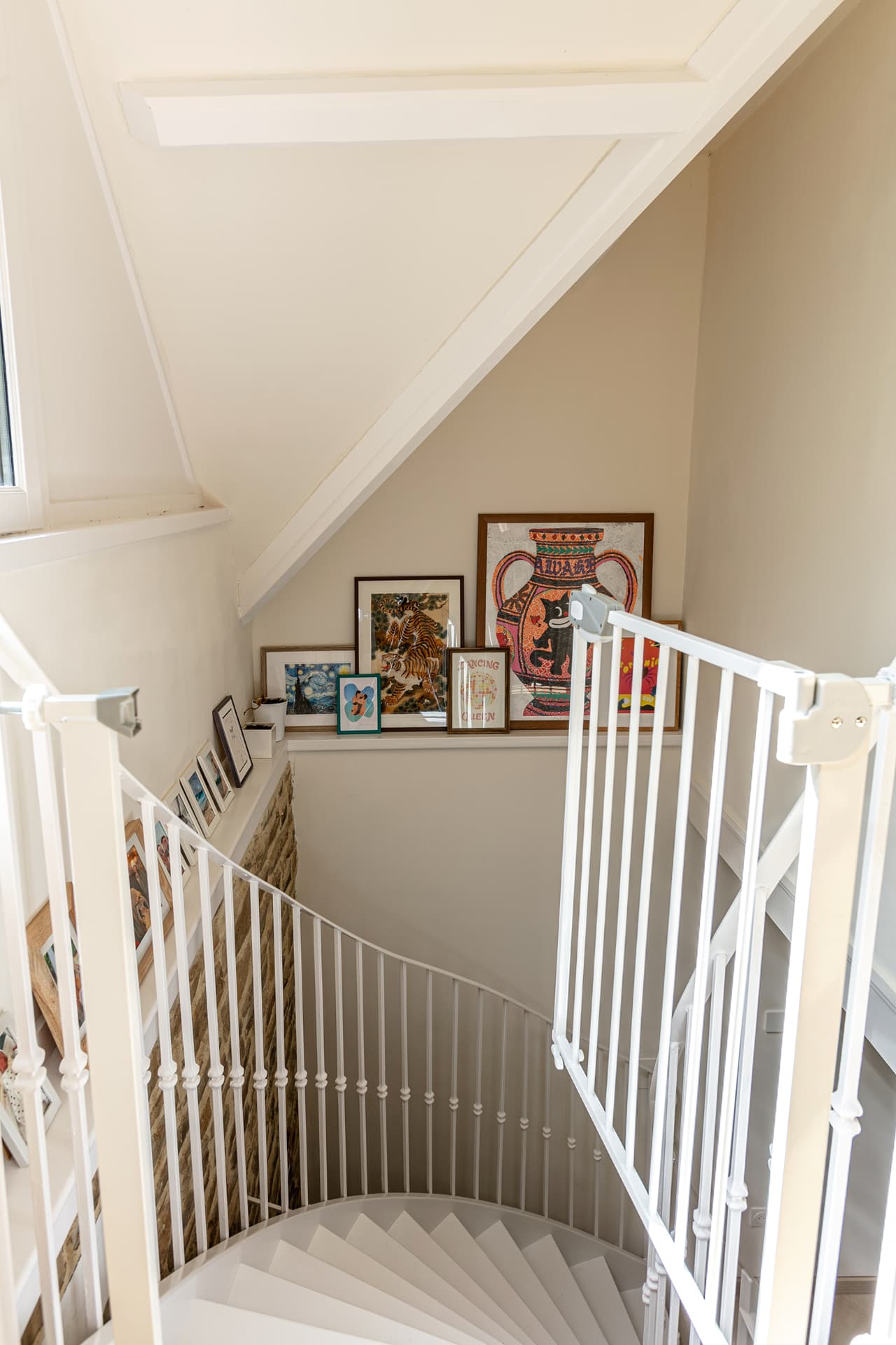 Spiral staircase lined with framed prints
