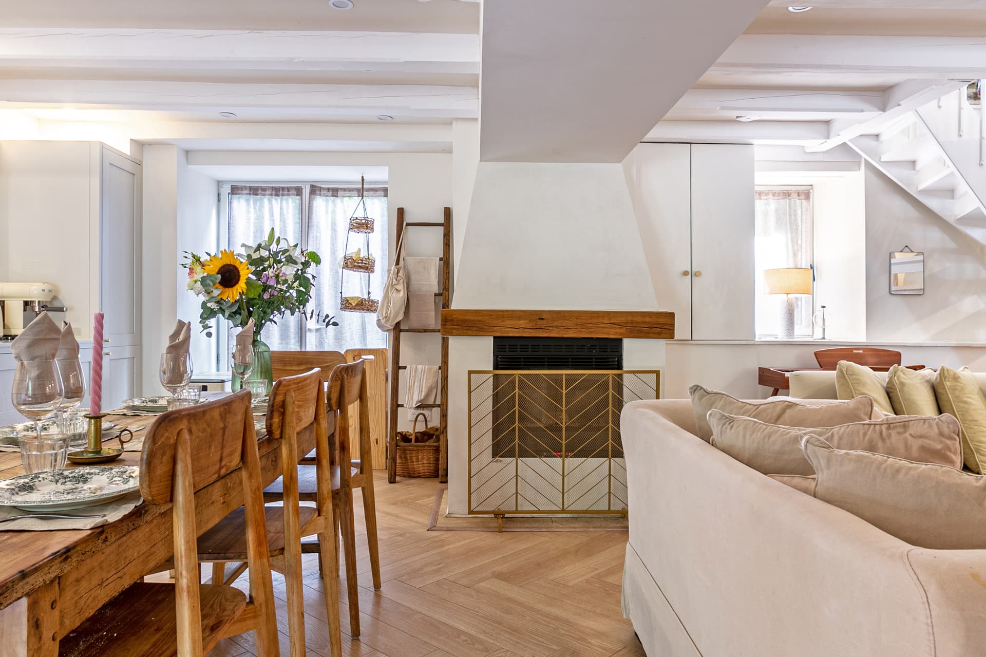 Dining table beside the fireplace with flowers on the table