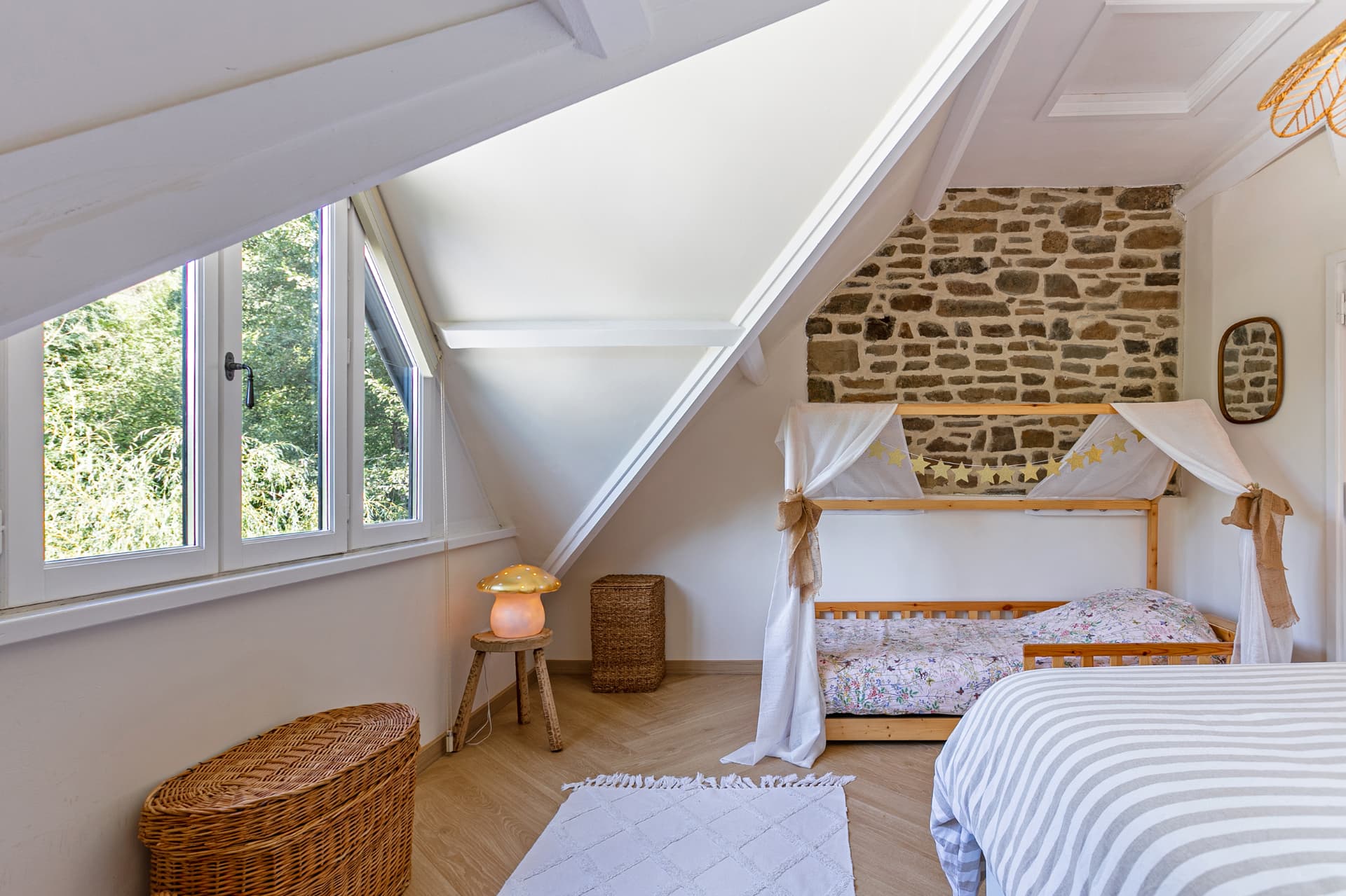 Family room with cabin bed beside an old stone wall