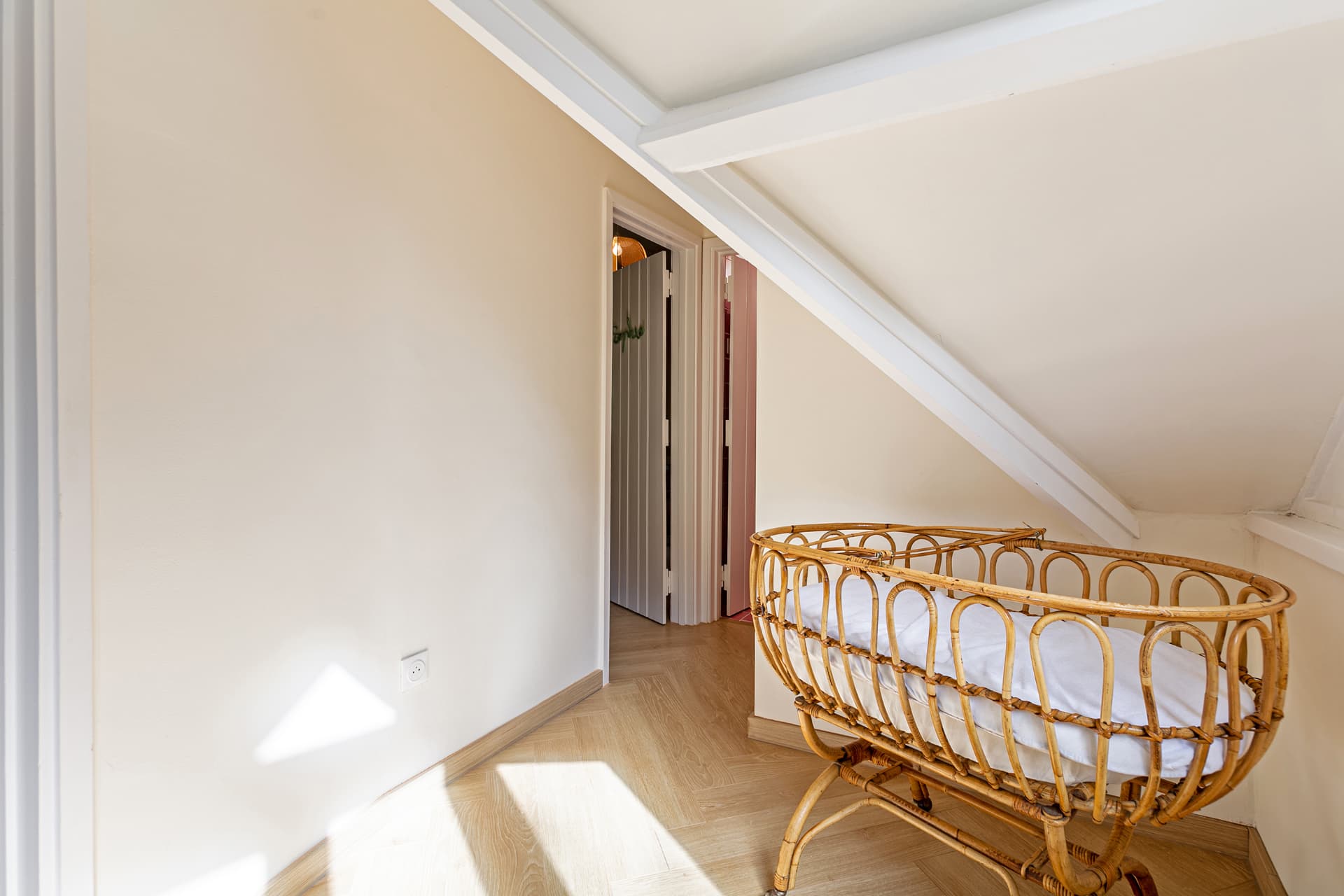 Vintage rattan cradle on the upstairs landing