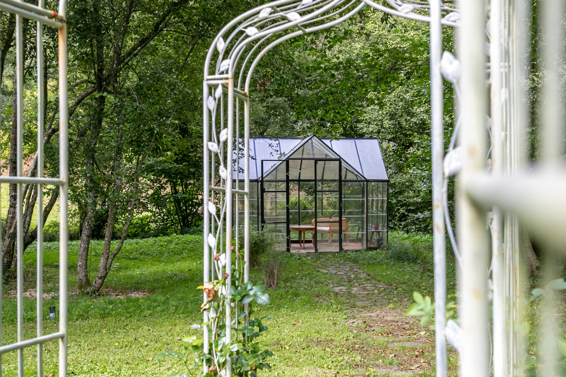 Stone path through the arches to the greenhouse