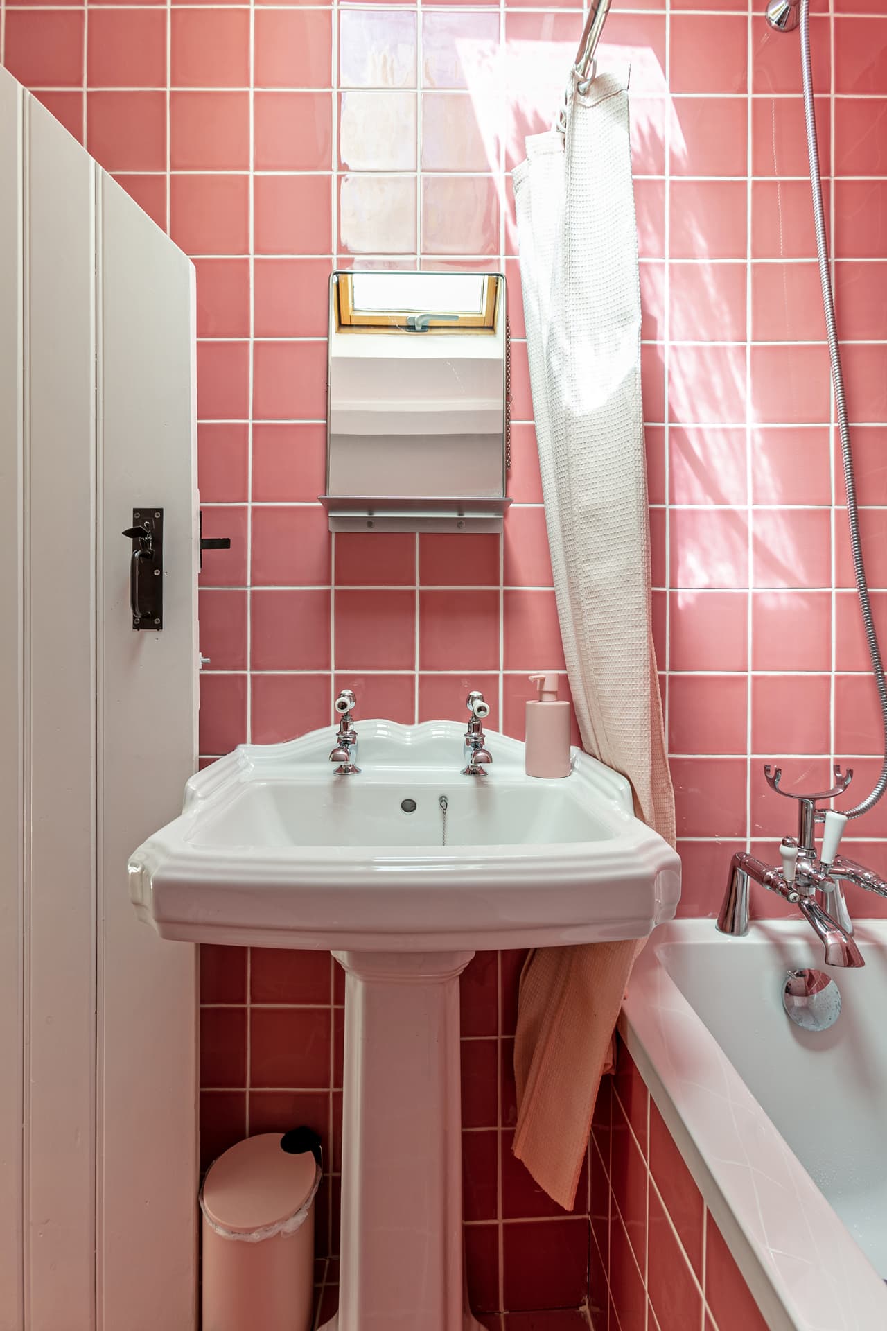 Classic pedestal basin against pink tiles