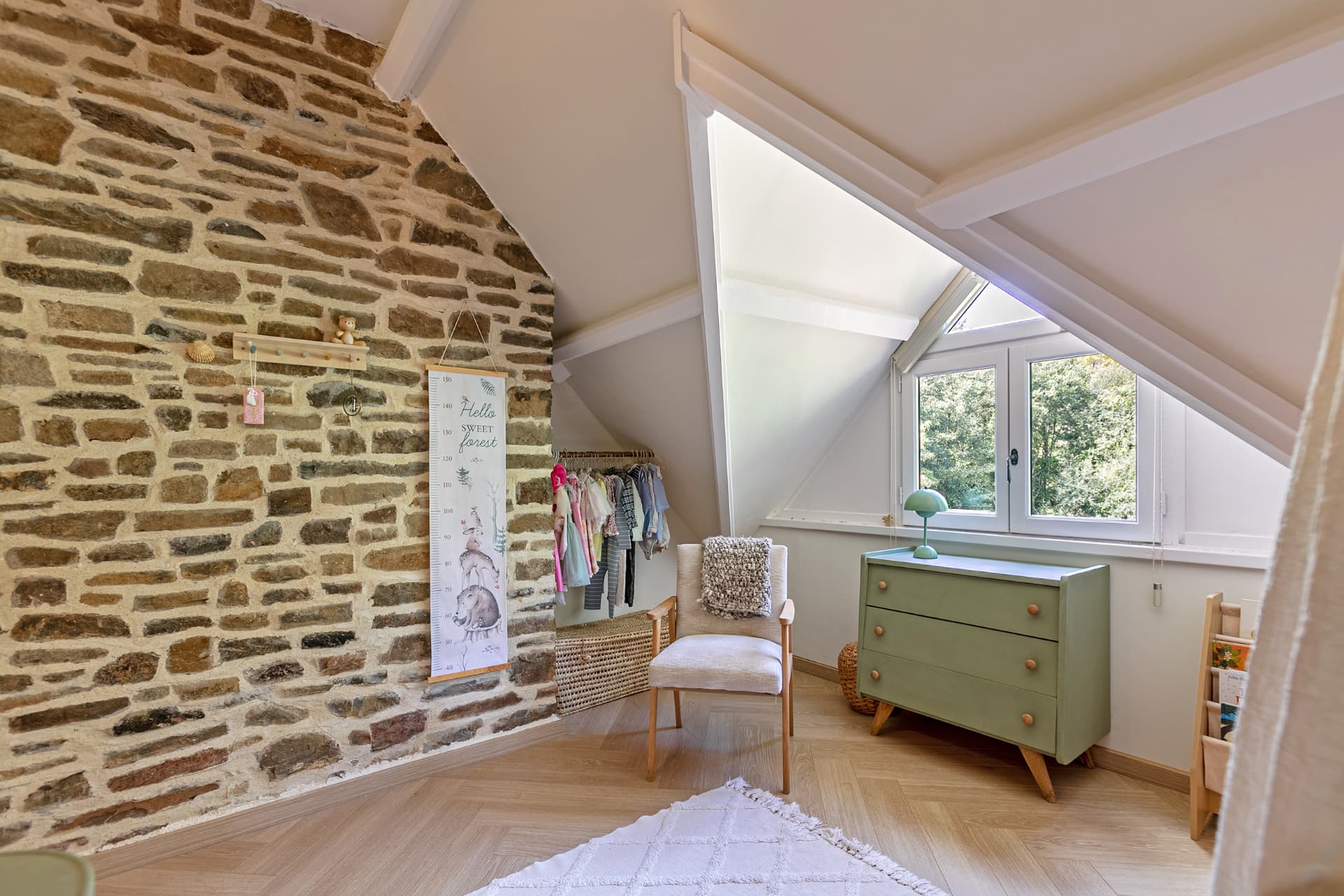 Children's room with stone wall and green chest of drawers