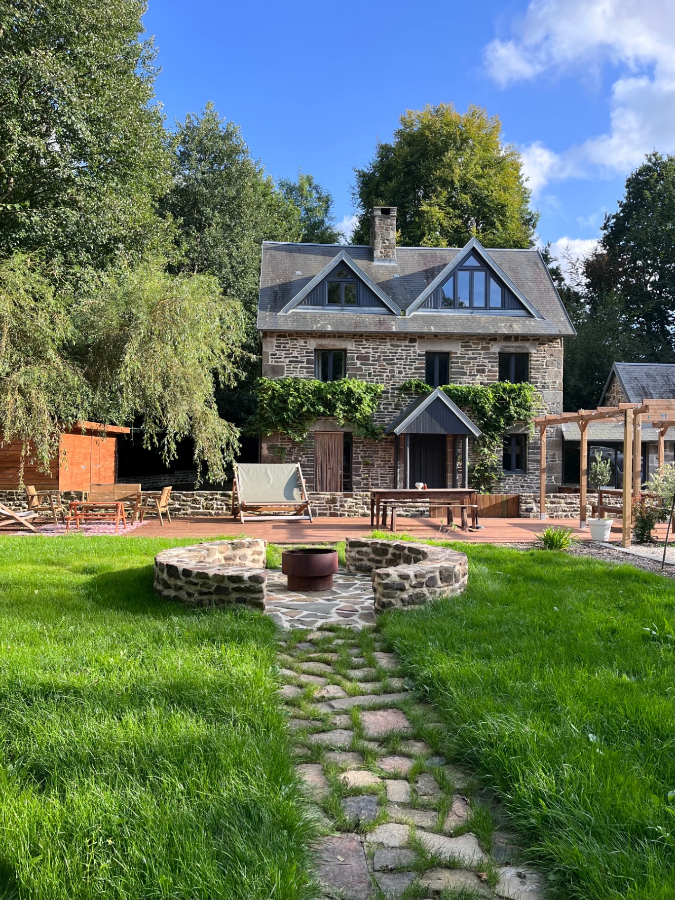 Stepping-stone path leading to the fire pit and stone house