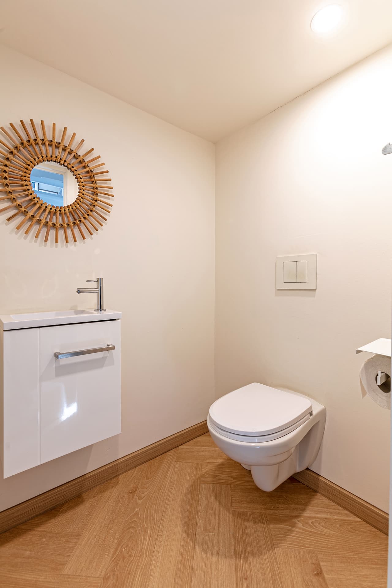 Downstairs WC with rattan sunburst mirror